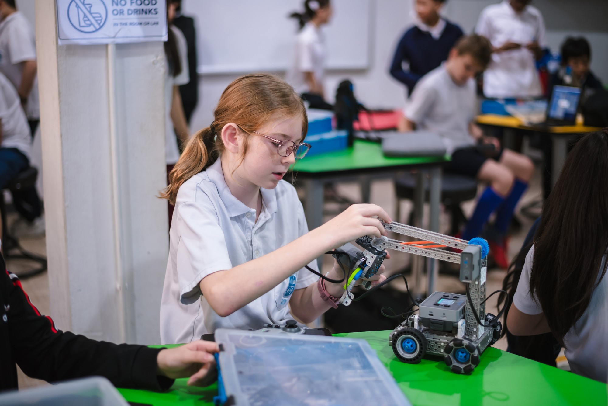 A student building a robot in class