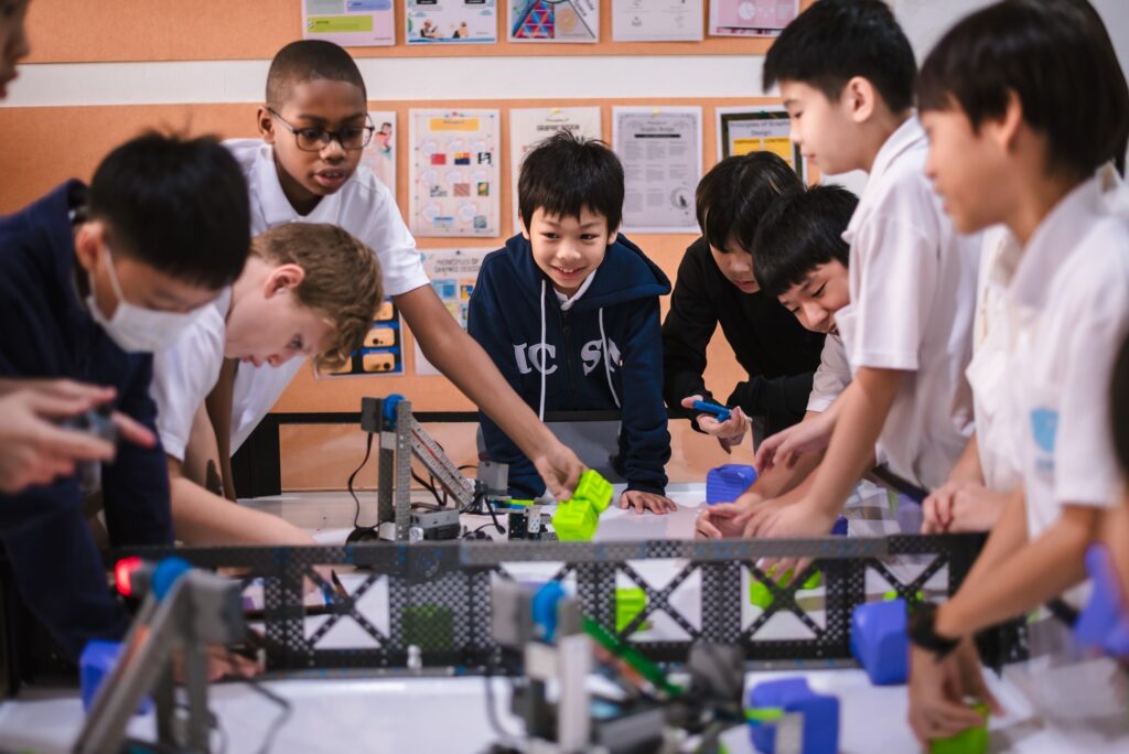 students in a classroom preparing for a robotics competition