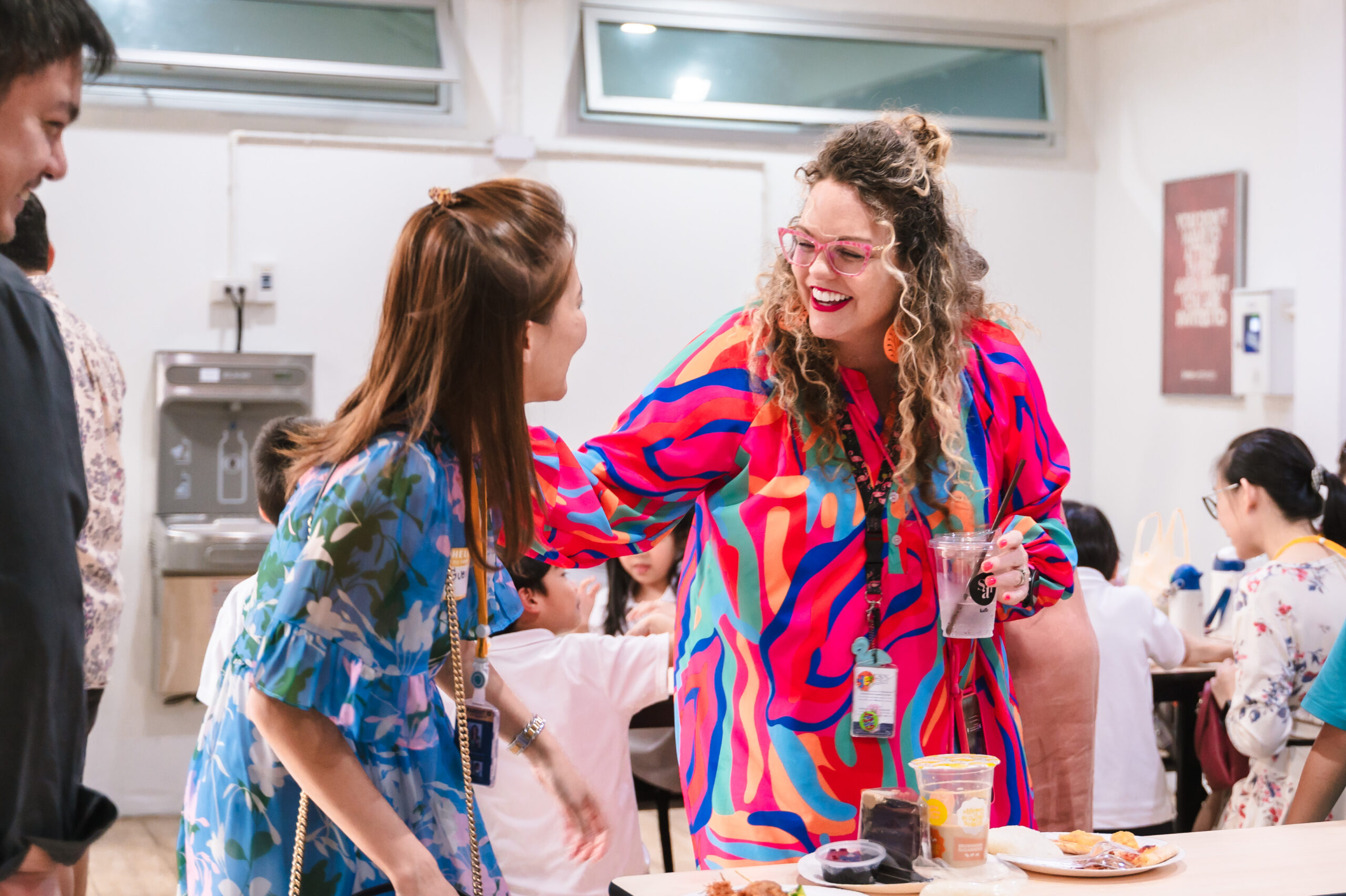 teacher and parent smiling as they talk