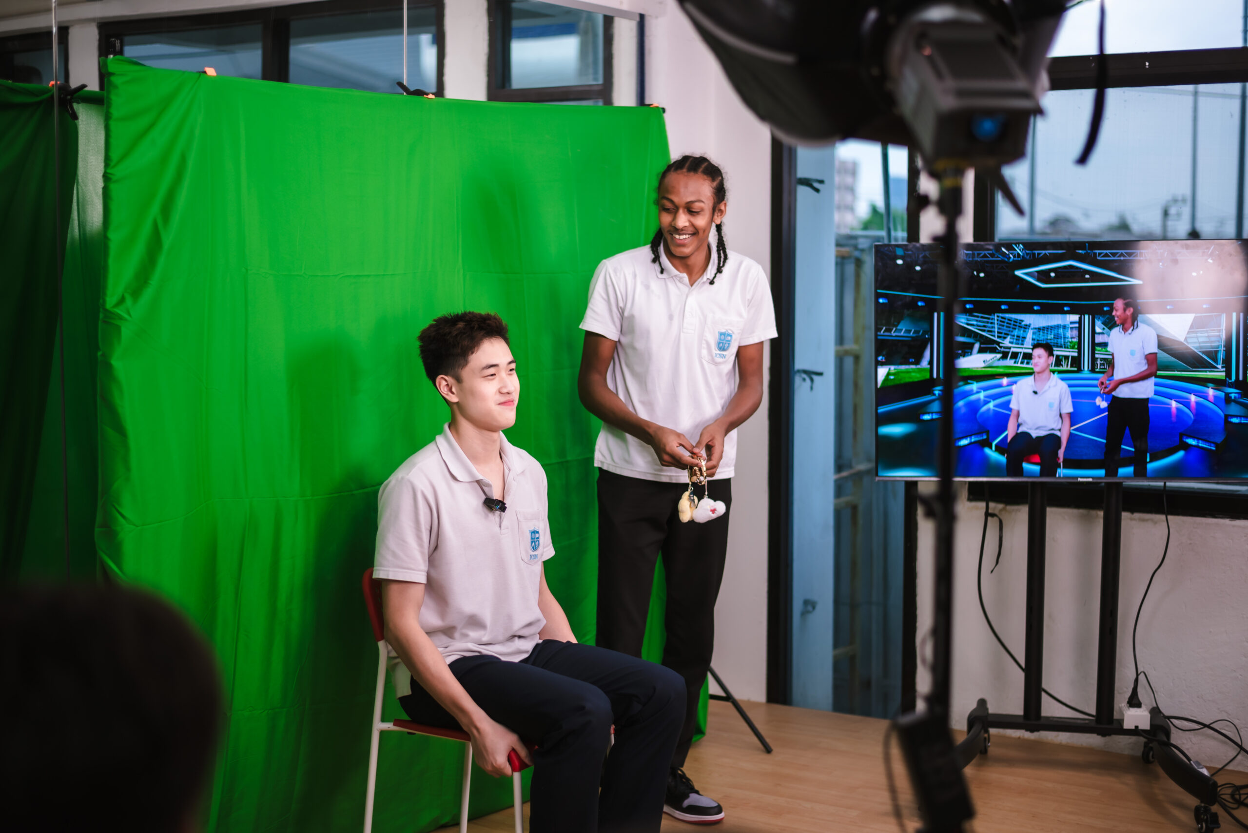 Students working with a green screen