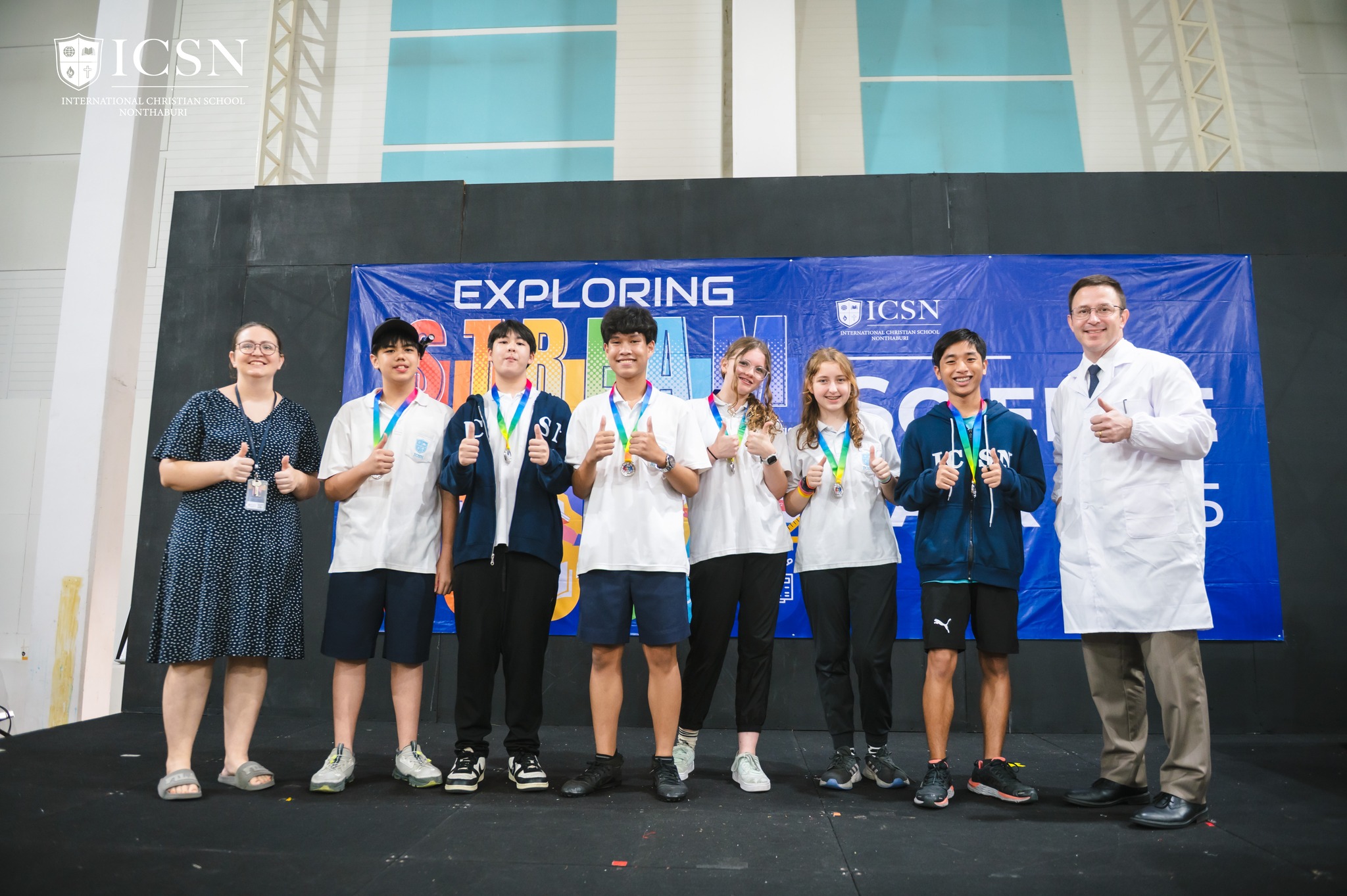 Students and teachers standing on stage for a science fair award