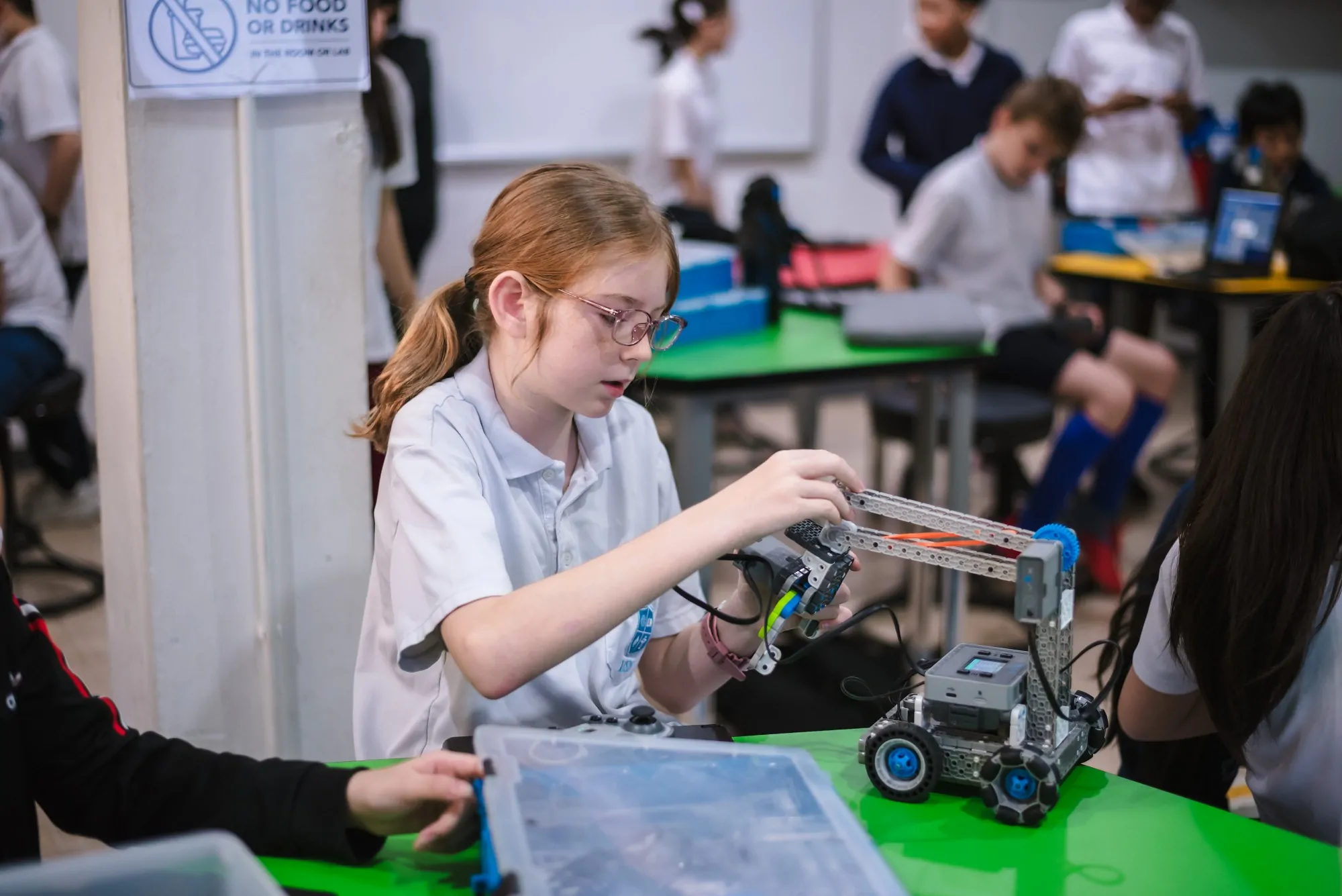 A student building a robot in class