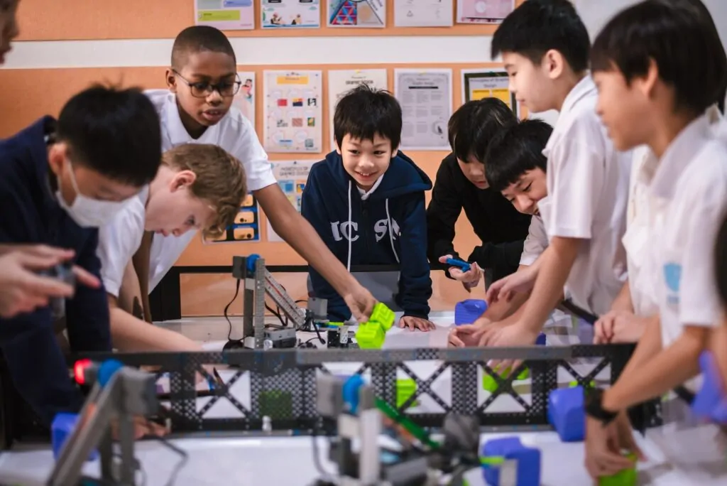 students in a classroom preparing for a robotics competition
