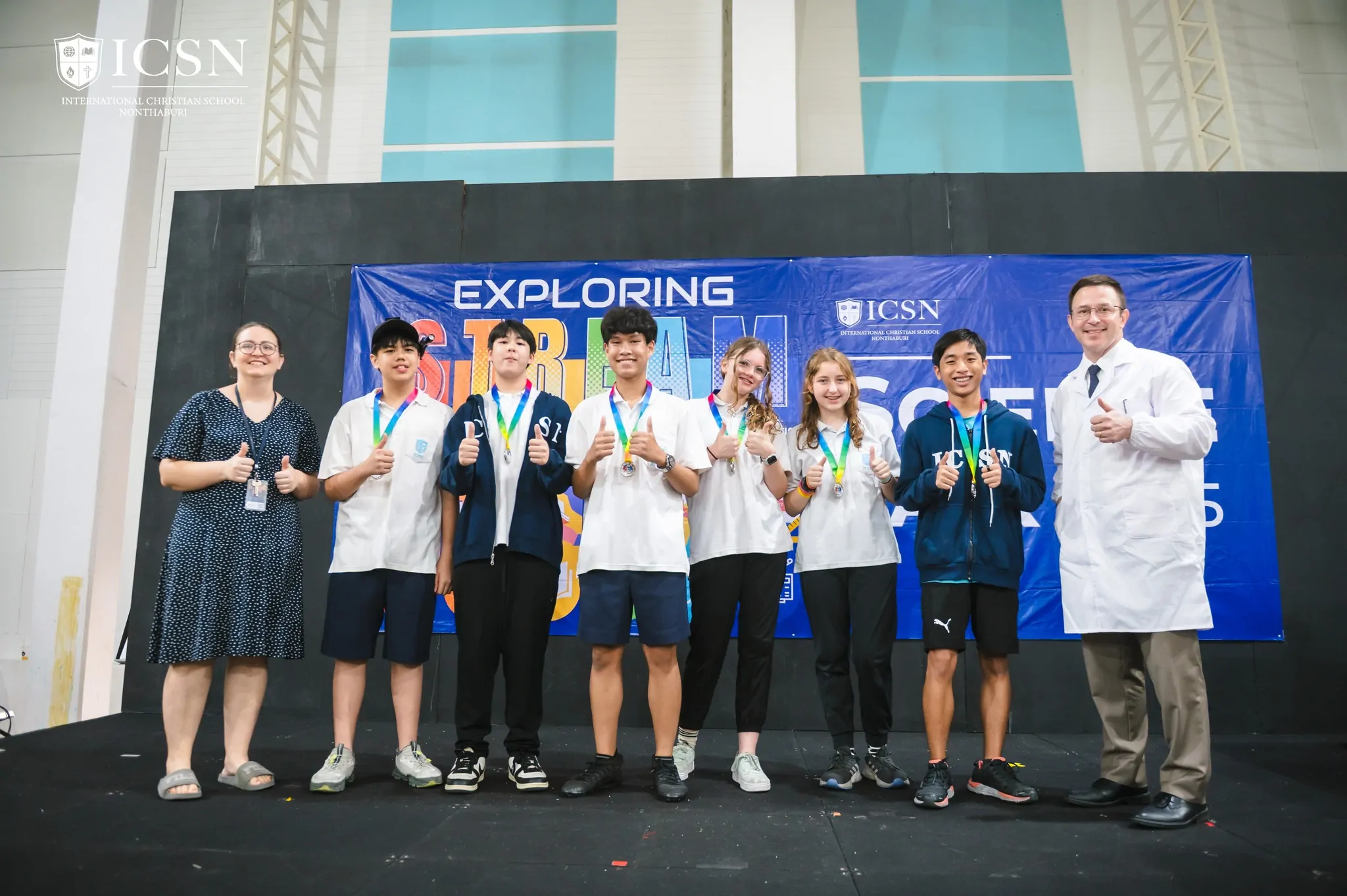 Students and teachers standing on stage for a science fair award